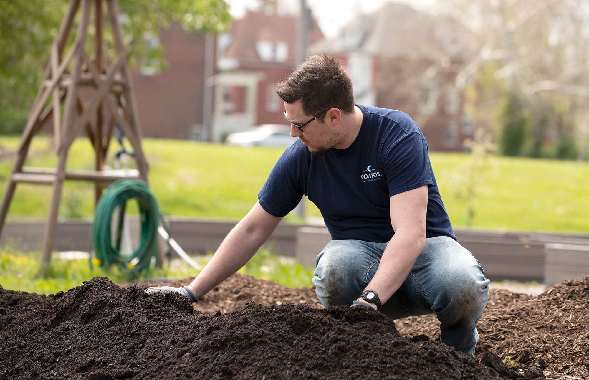 Cosmos employee preparing dirt for planting