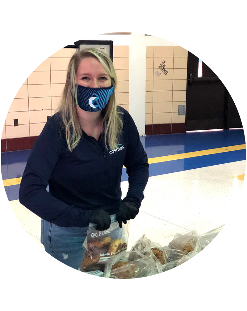 A cosmos employee volunteering at a food drive